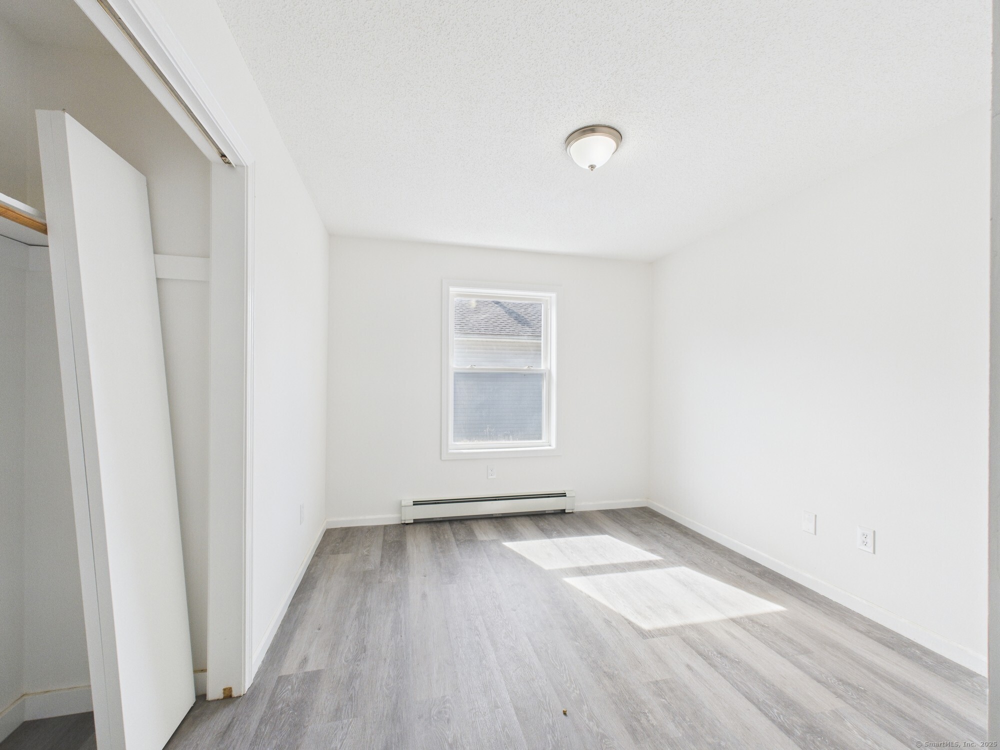 23 Dewitt Street New Haven, CT 06519 - Photo 6 of 36 an empty room with wooden floor and windows