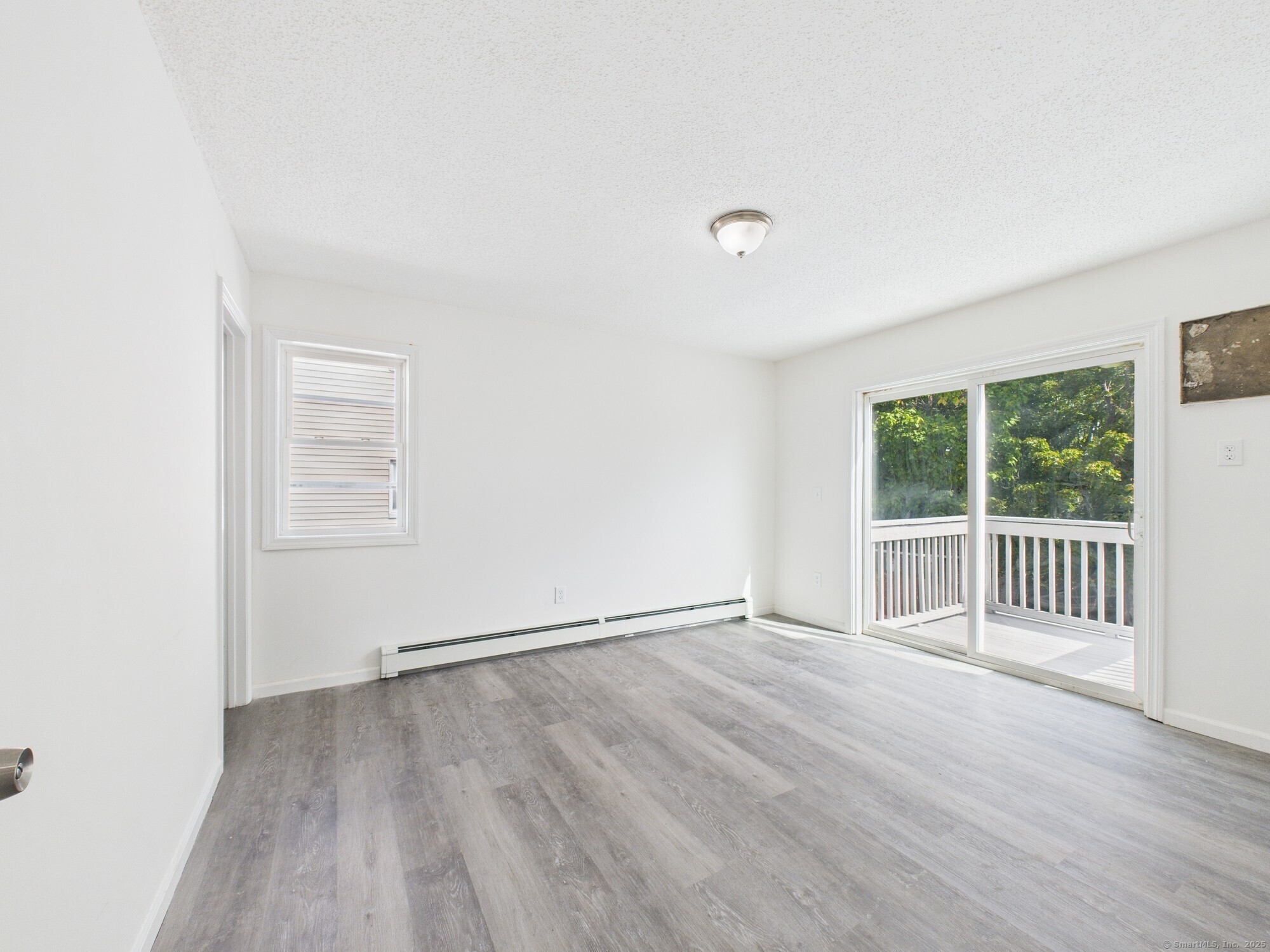 23 Dewitt Street New Haven, CT 06519 - Photo 8 of 36 an empty room with wooden floor and windows