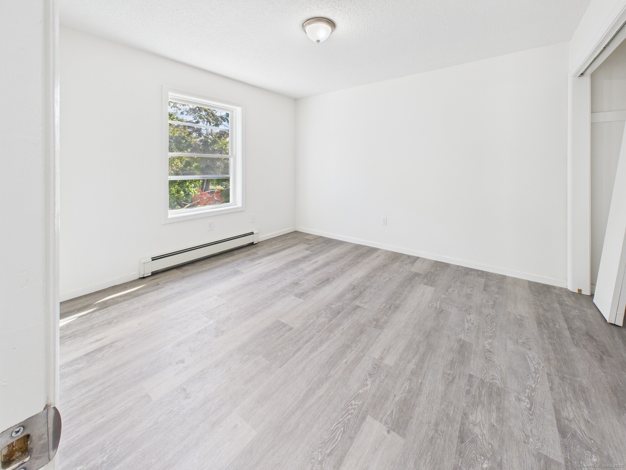23 Dewitt Street New Haven, CT 06519 - Photo 10 of 36 an empty room with wooden floor and windows