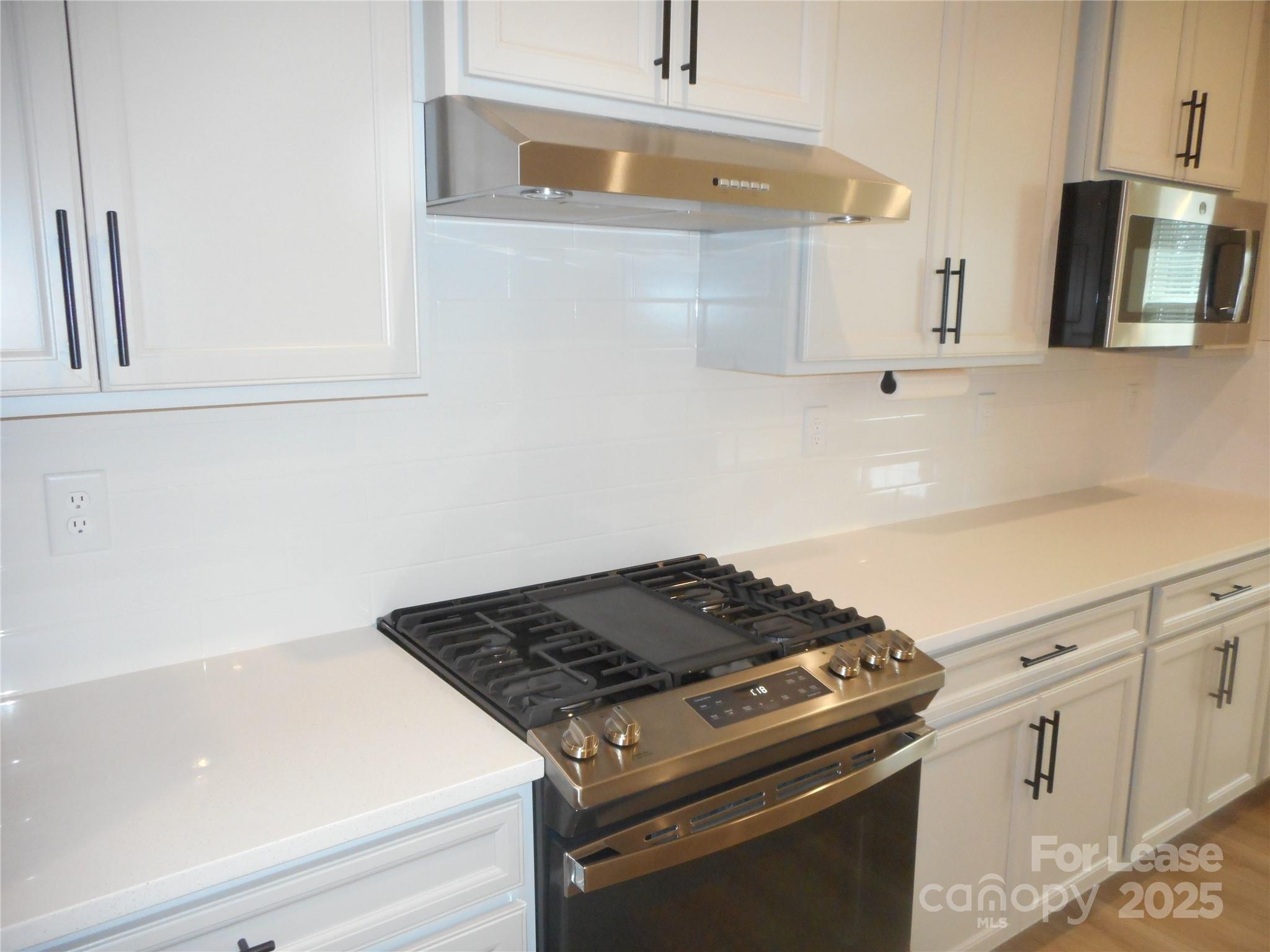 3033 Matthews-Indian Trail Road Matthews, NC 28104 - Photo 12 of 30 a stove top oven sitting inside of a kitchen