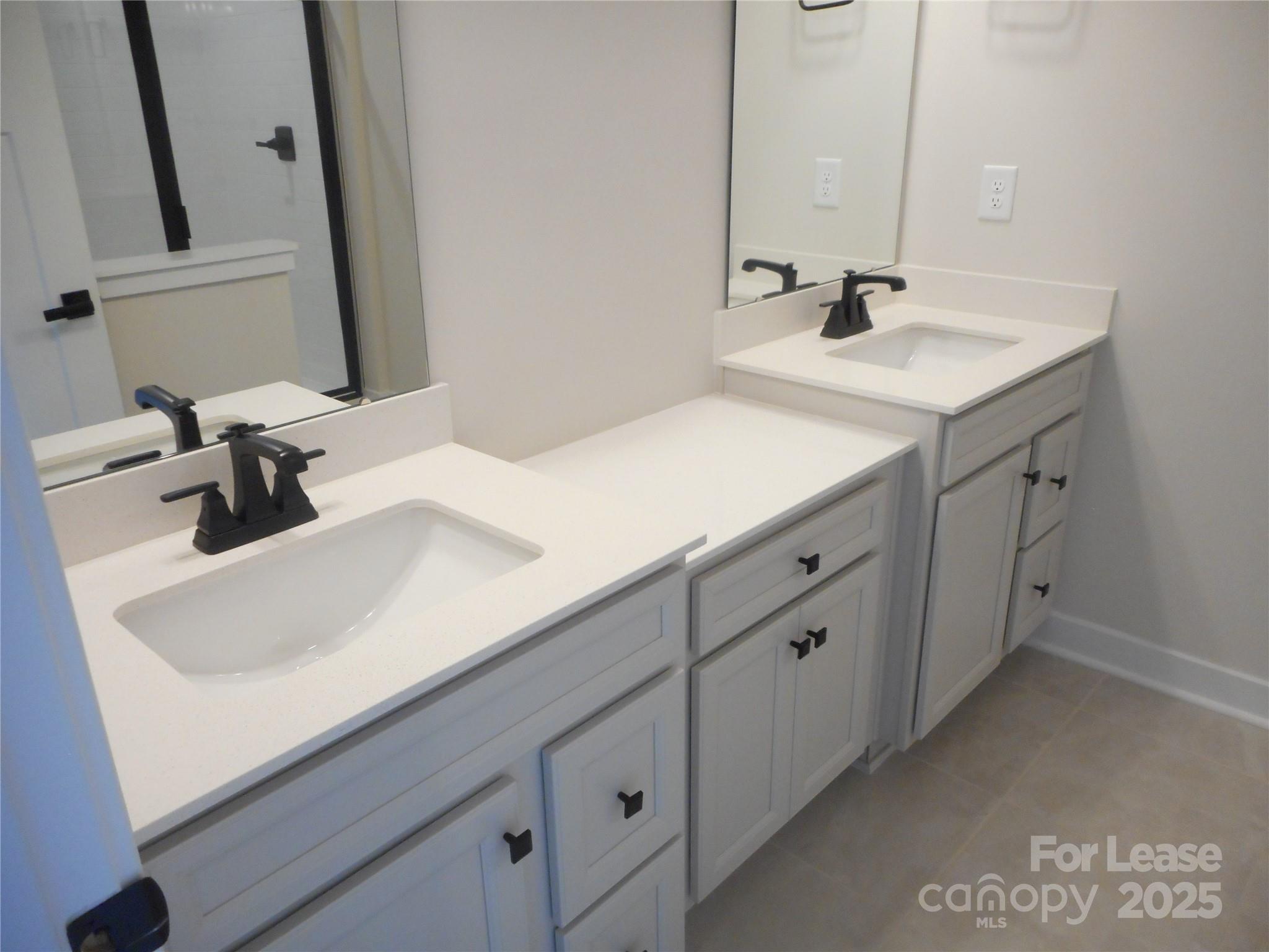 3033 Matthews-Indian Trail Road Matthews, NC 28104 - Photo 22 of 30 a bathroom with a sink and a mirror