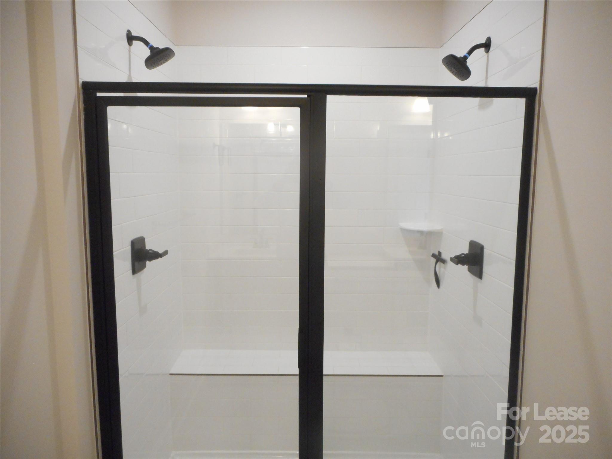 3033 Matthews-Indian Trail Road Matthews, NC 28104 - Photo 23 of 30 a bathroom with a glass shower door