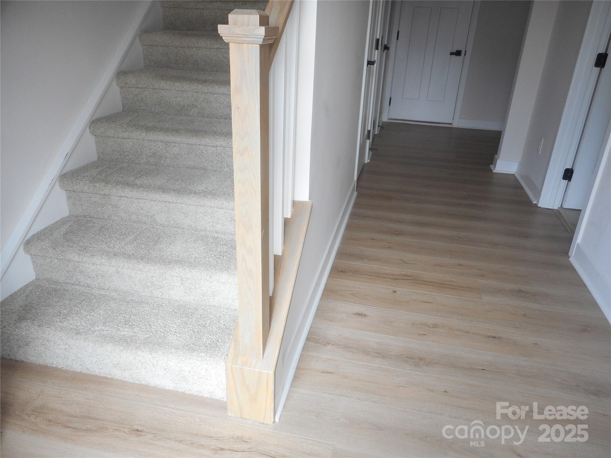 3033 Matthews-Indian Trail Road Matthews, NC 28104 - Photo 7 of 30 a view of a hallway with wooden floor and staircase