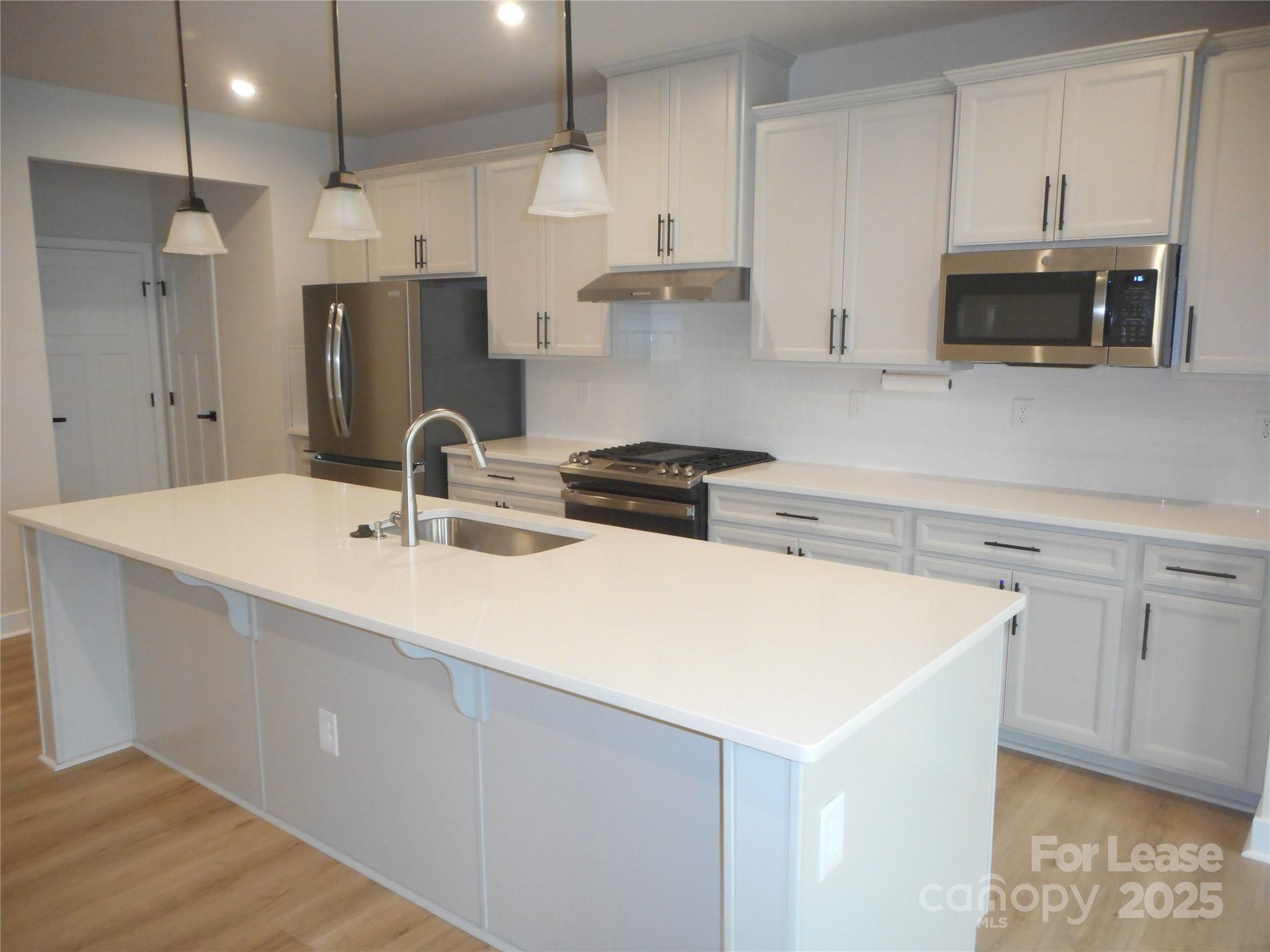 3033 Matthews-Indian Trail Road Matthews, NC 28104 - Photo 8 of 30 a kitchen with appliances a sink a stove and cabinets