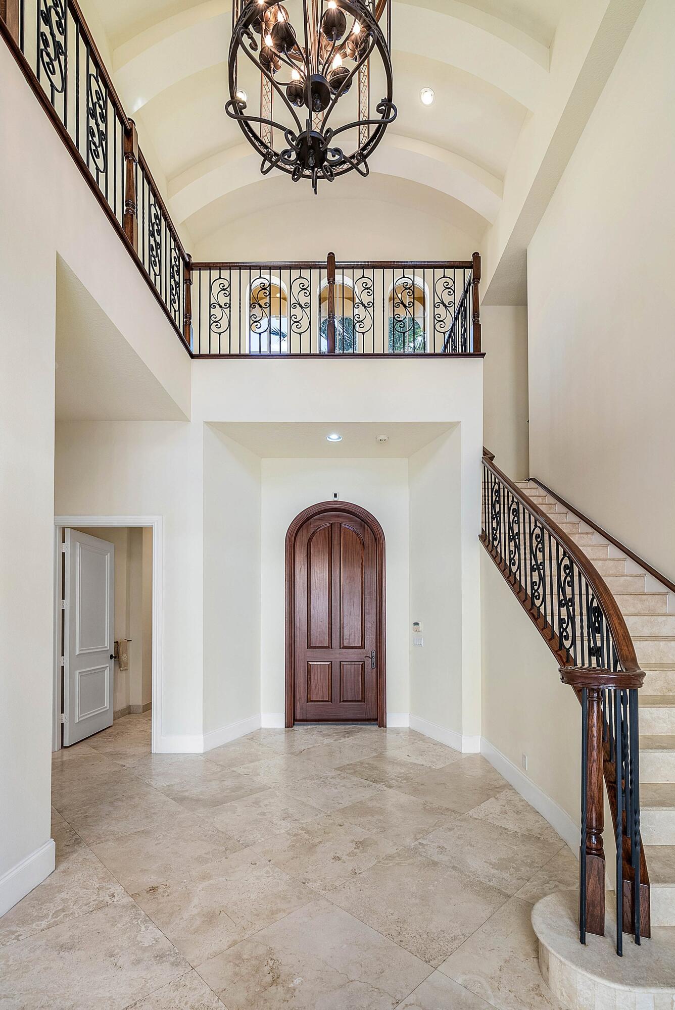 17387 Balaria Street Boca Raton, FL 33496 - Photo 13 of 65 a view of a hallway with entryway wooden floor and front door