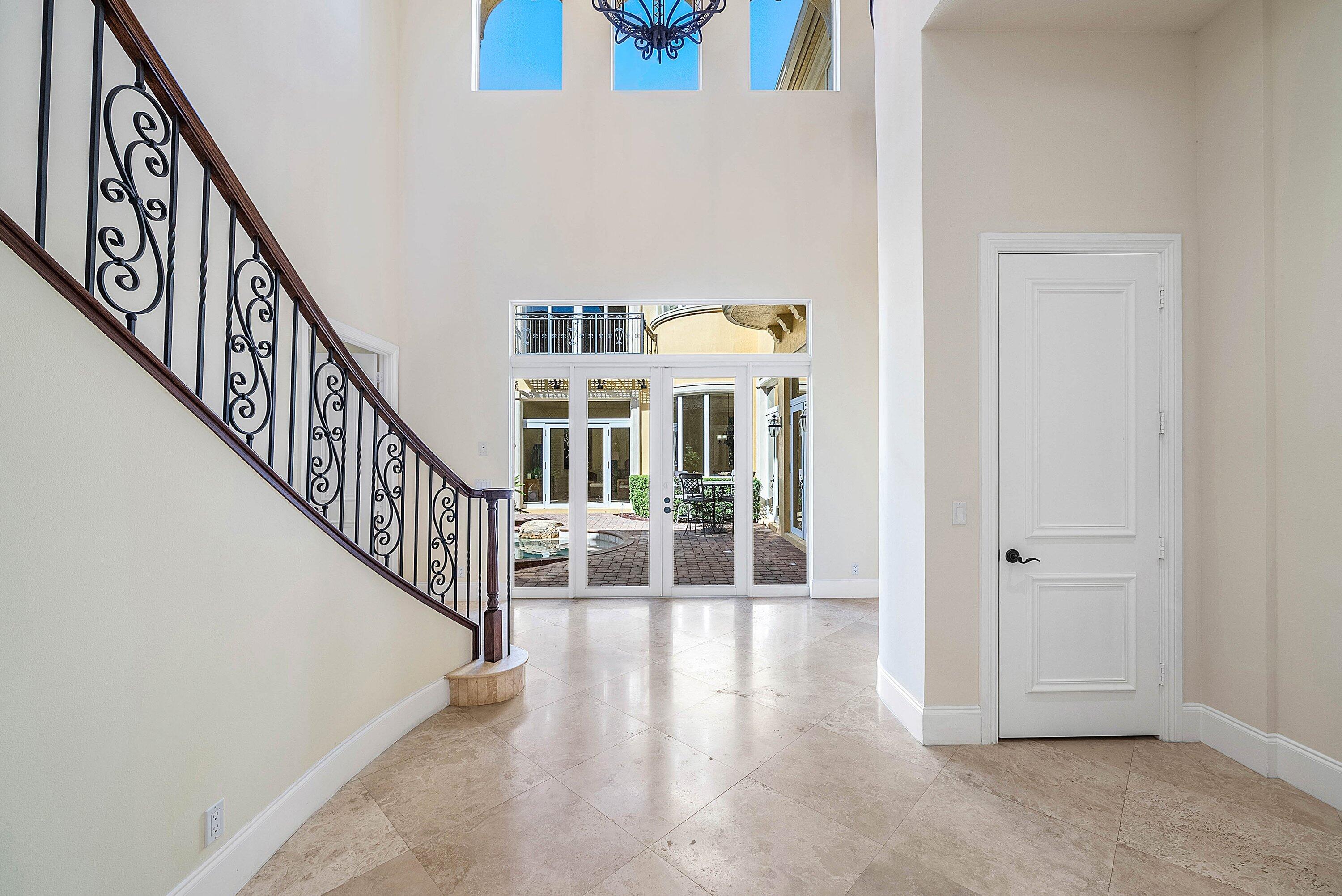 17387 Balaria Street Boca Raton, FL 33496 - Photo 15 of 65 a view of staircase with lots of frames on wall and a window