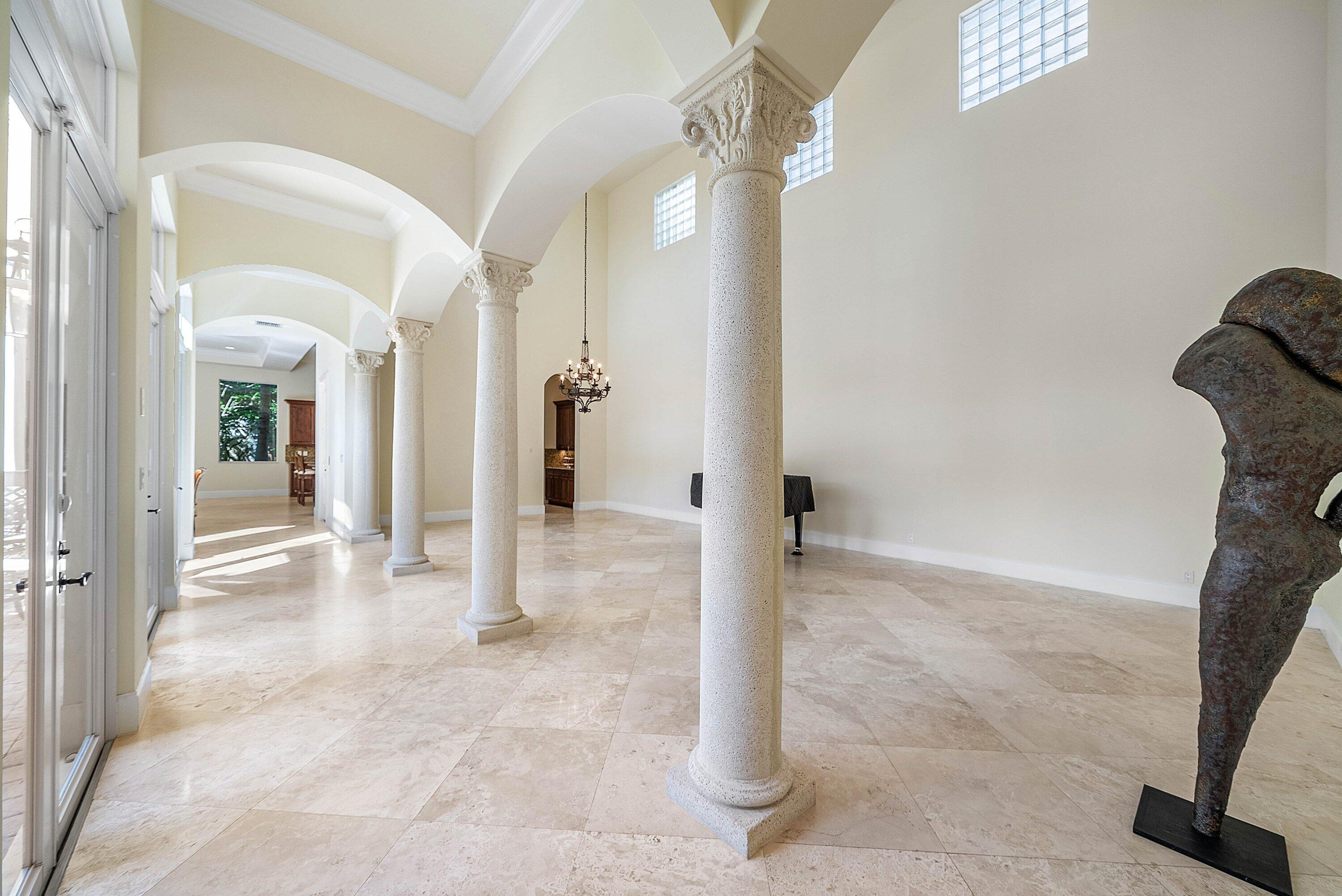 17387 Balaria Street Boca Raton, FL 33496 - Photo 17 of 65 a view of a hallway with chandelier and glass door