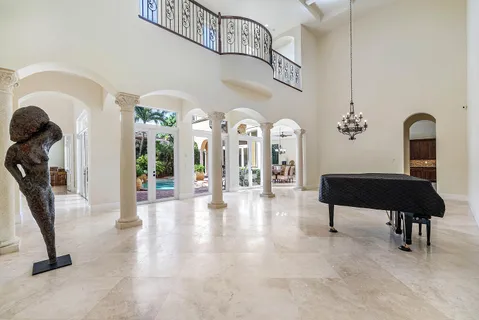 a view of a dining room with furniture and a chandelier