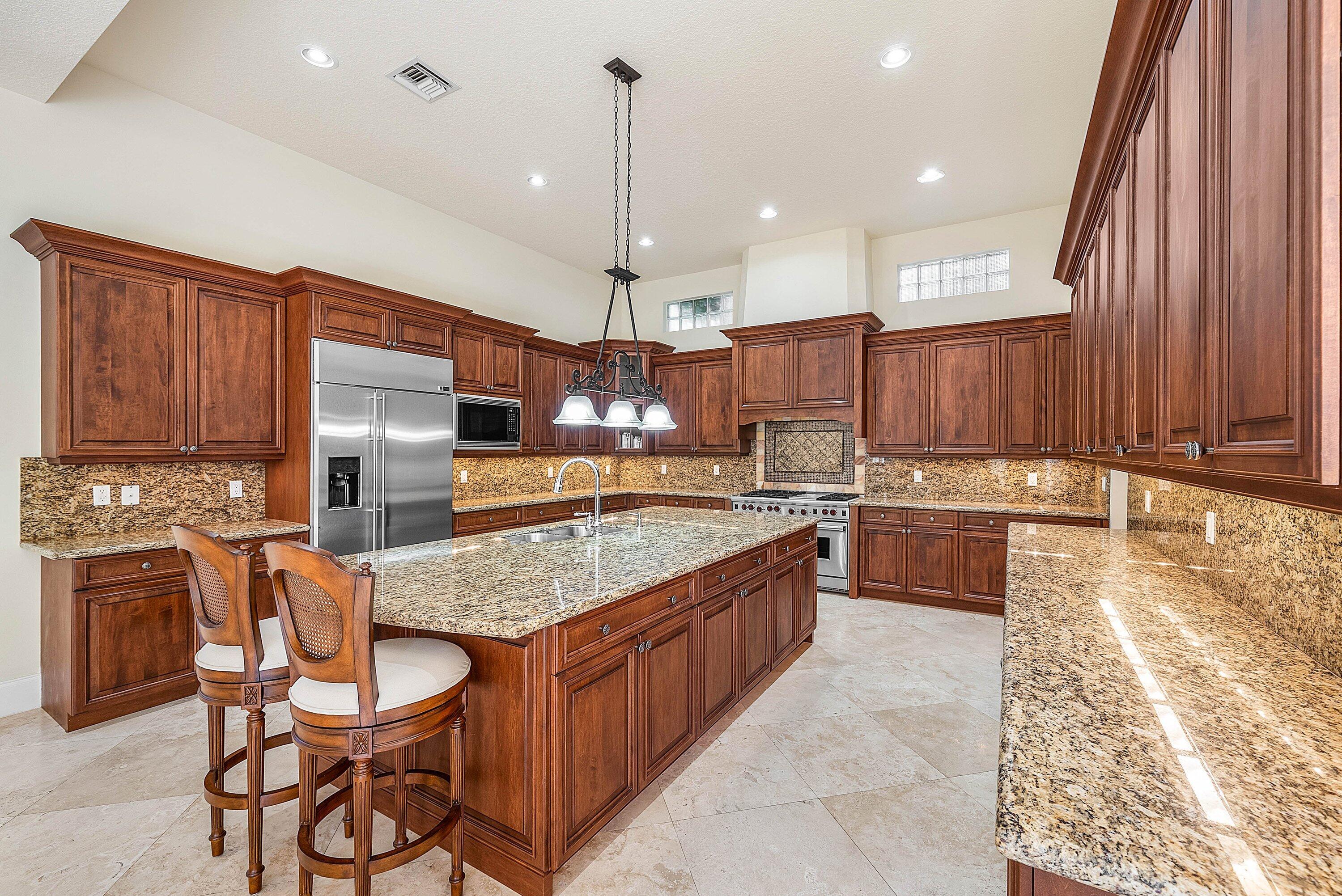 17387 Balaria Street Boca Raton, FL 33496 - Photo 21 of 65 a large kitchen with a table and chairs