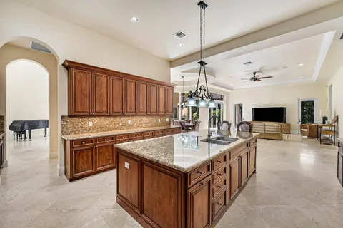 a living room with furniture kitchen view and a large window
