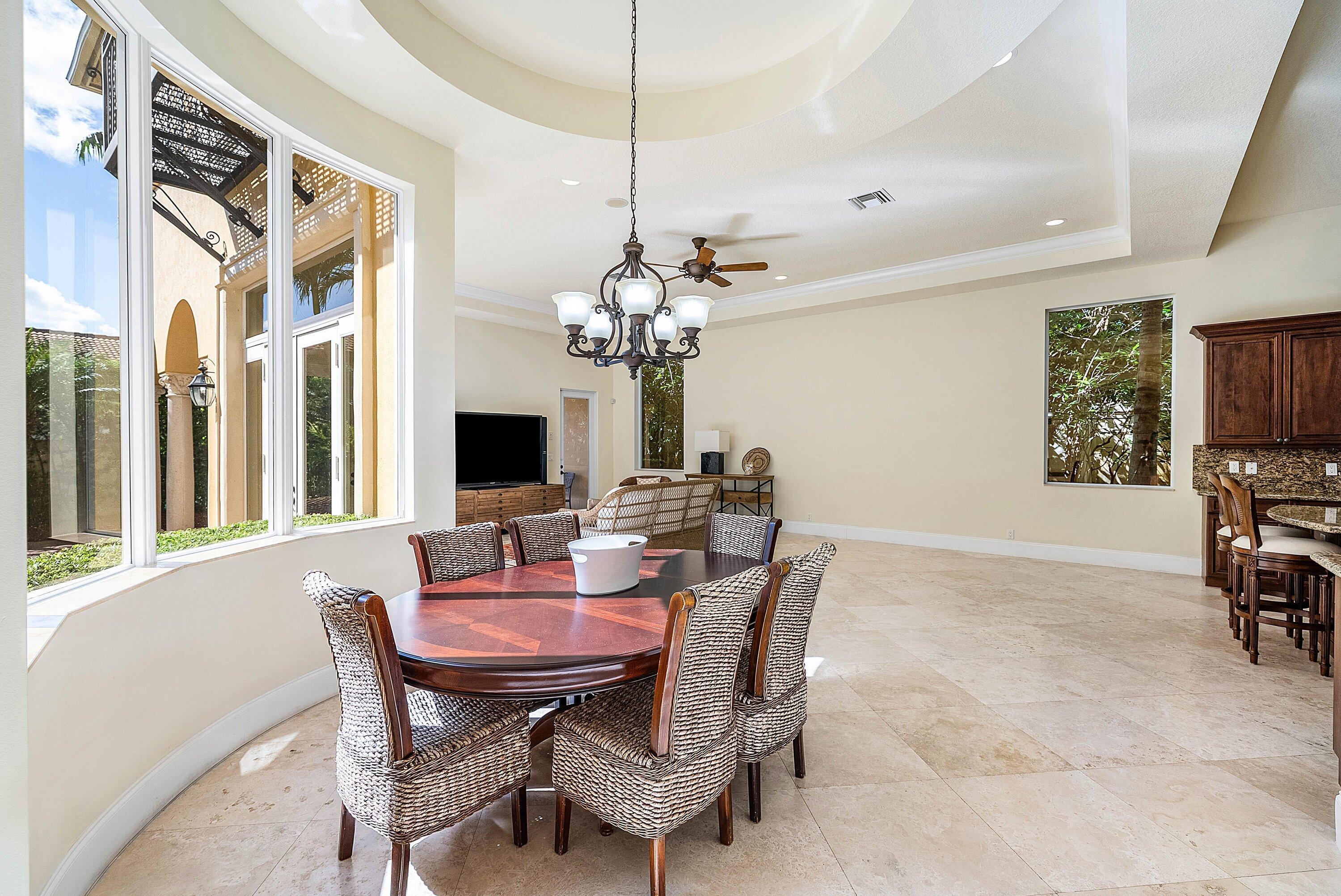 17387 Balaria Street Boca Raton, FL 33496 - Photo 24 of 65 a view of a dining room with furniture and a chandelier