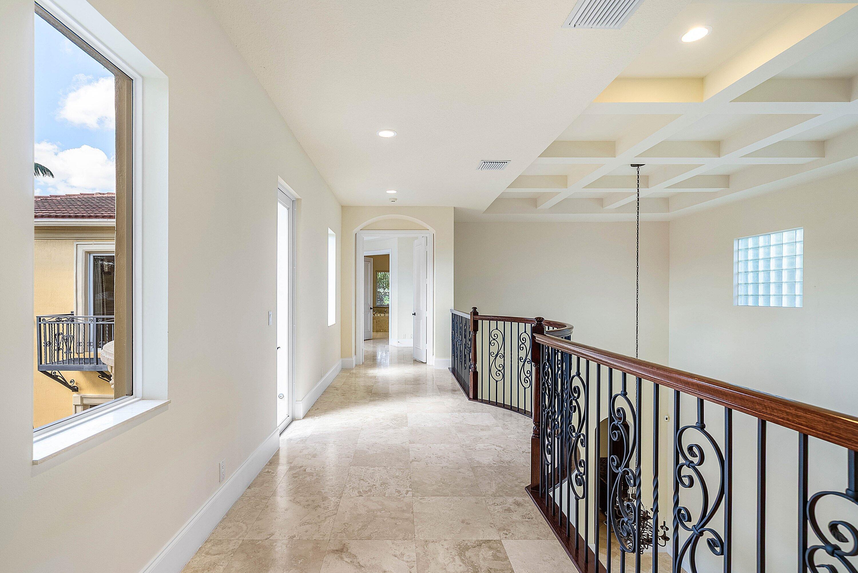 17387 Balaria Street Boca Raton, FL 33496 - Photo 37 of 65 a view of a hallway with windows