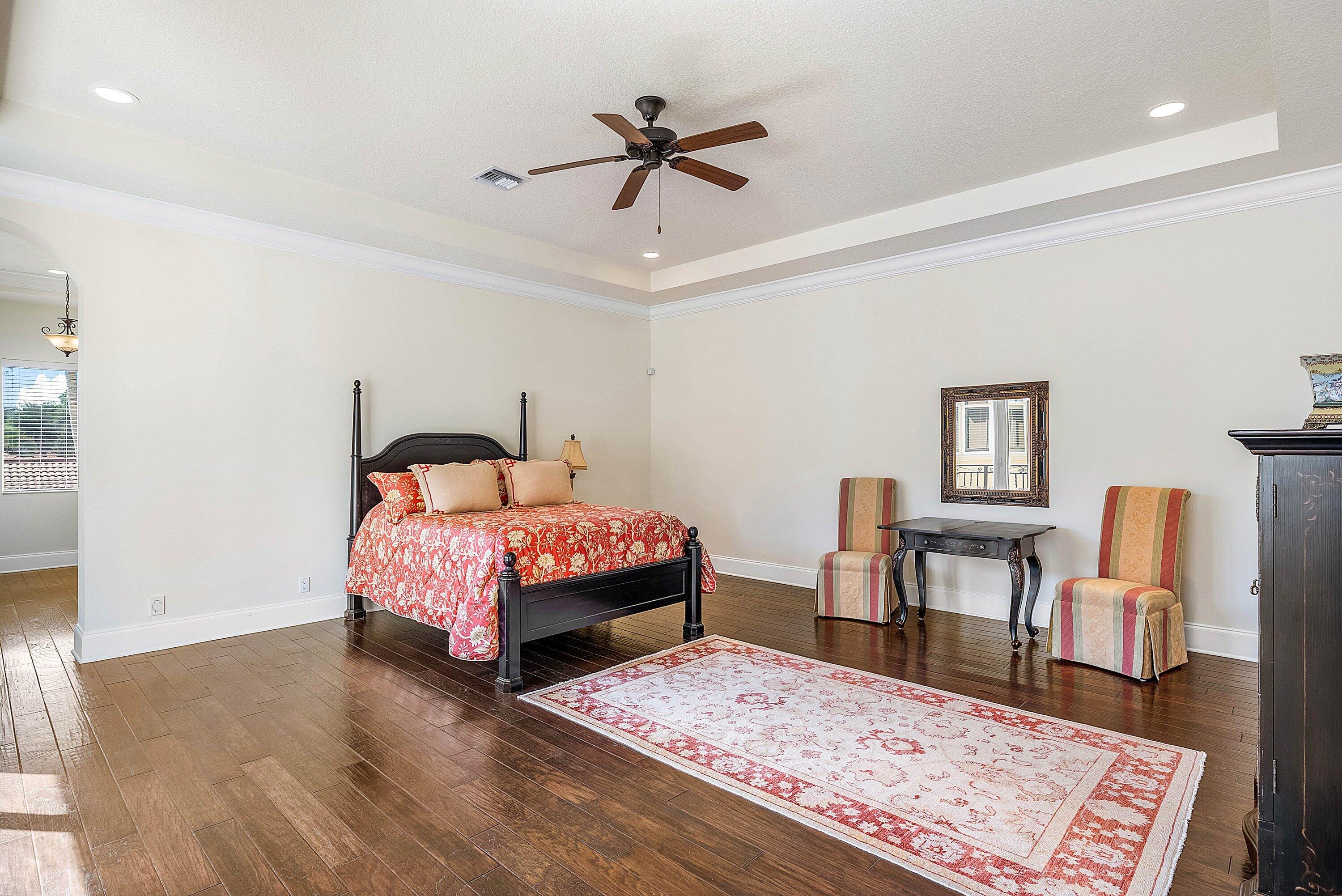 17387 Balaria Street Boca Raton, FL 33496 - Photo 39 of 65 a bed room with a bed a chair and a potted plant