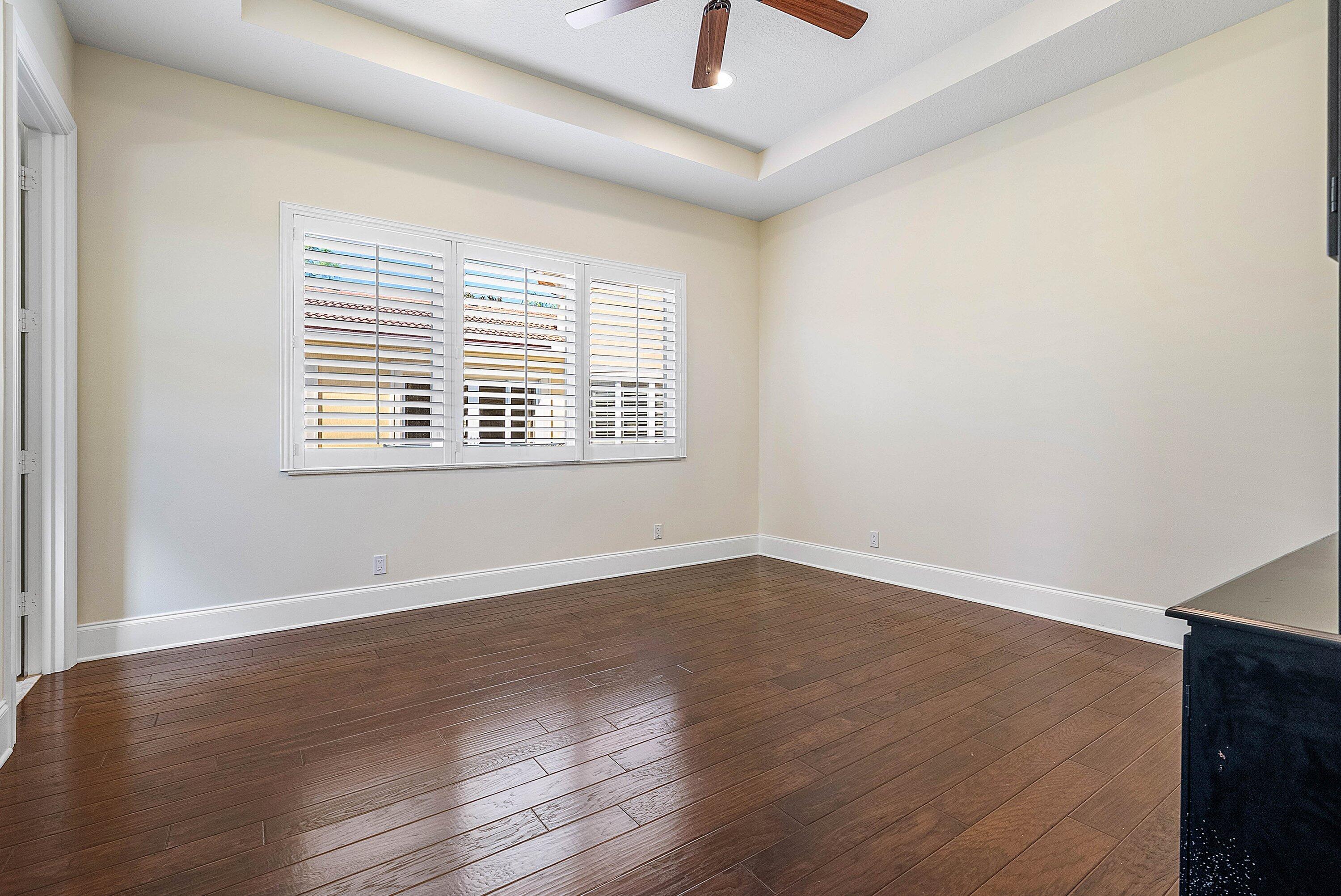 17387 Balaria Street Boca Raton, FL 33496 - Photo 51 of 65 an empty room with wooden floor and windows
