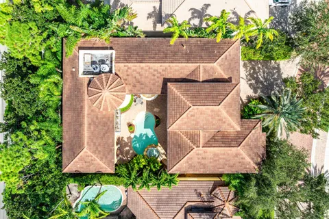 a view of staircase with lots of frames on wall and a window