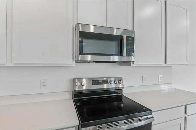 a kitchen with a stove and a microwave