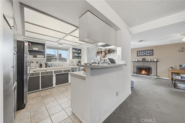 a kitchen with stainless steel appliances granite countertop a refrigerator and a stove
