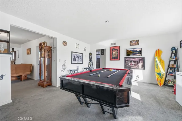 a bedroom with a bed and a view of living room