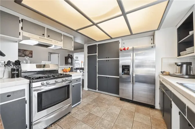 a kitchen with stainless steel appliances granite countertop a stove a refrigerator and a refrigerator