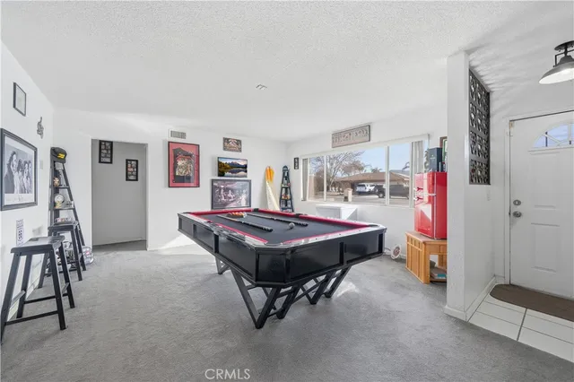 a room with pool table and furniture