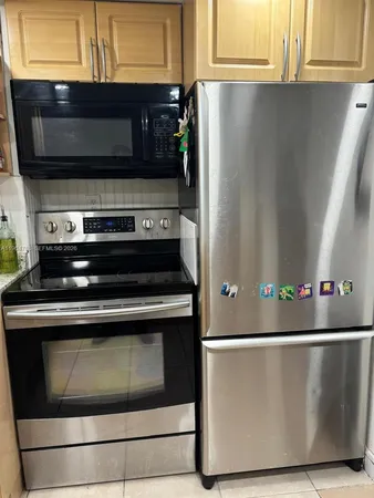 a stove top oven sitting inside of a kitchen
