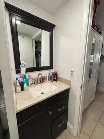 a bathroom with a double vanity sink and a mirror