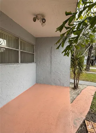 a potted plant sitting in front of a house