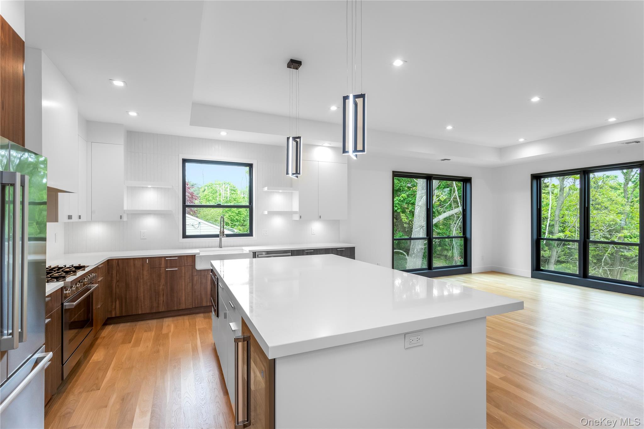 600 Glenn Road Southold, NY 11971 - Photo 14 of 22 a view of a kitchen with kitchen island a large counter top space a sink stainless steel appliances and windows
