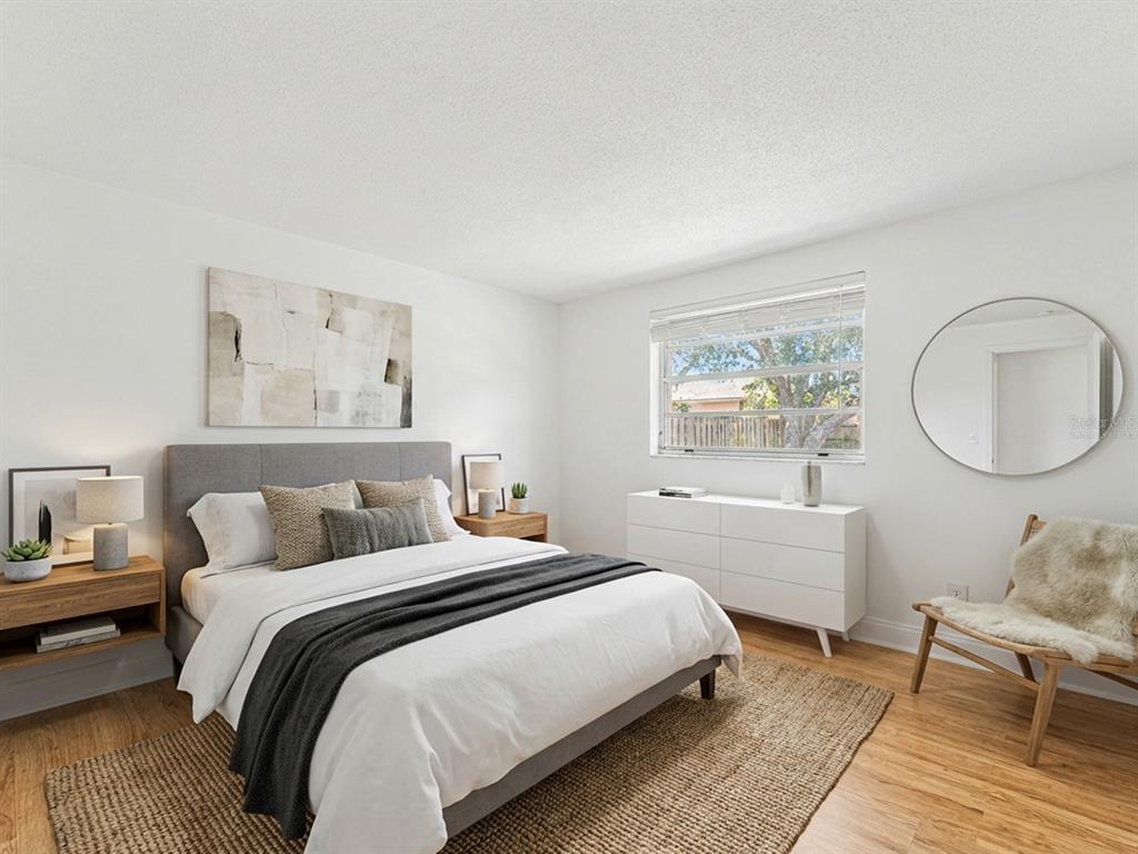 9430 Gray Fox Lane Port Richey, FL 34668 - Photo 17 of 33 a bedroom with a bed a mirror and a window