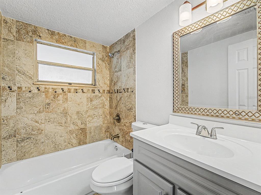 9430 Gray Fox Lane Port Richey, FL 34668 - Photo 21 of 33 a bathroom with a sink a toilet and a bathtub
