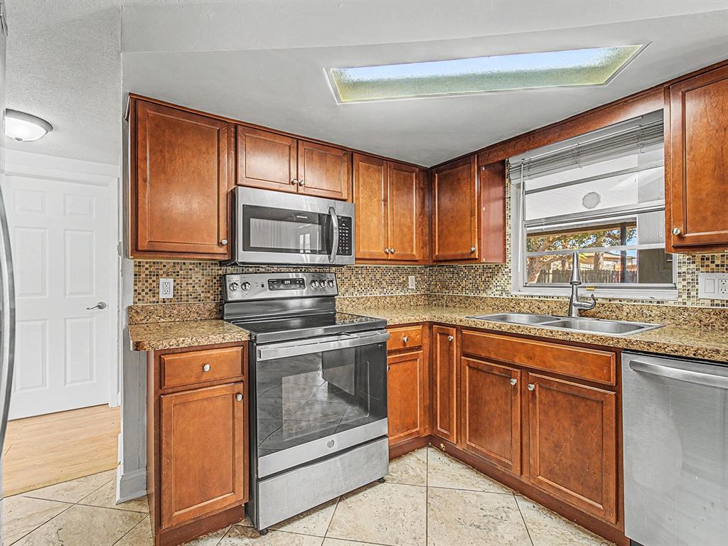 9430 Gray Fox Lane Port Richey, FL 34668 - Photo 7 of 33 a kitchen with granite countertop cabinets stainless steel appliances and a counter space