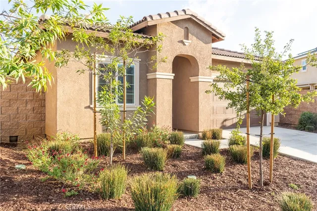 a front view of a house with garden