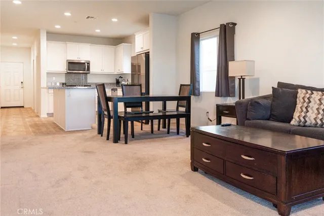 a living room with furniture and large windows