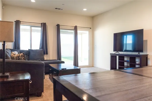 a living room with furniture and a large window