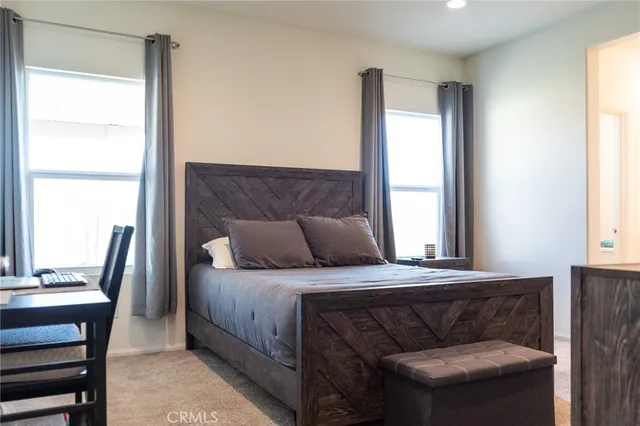 a bedroom with a bed and a couch