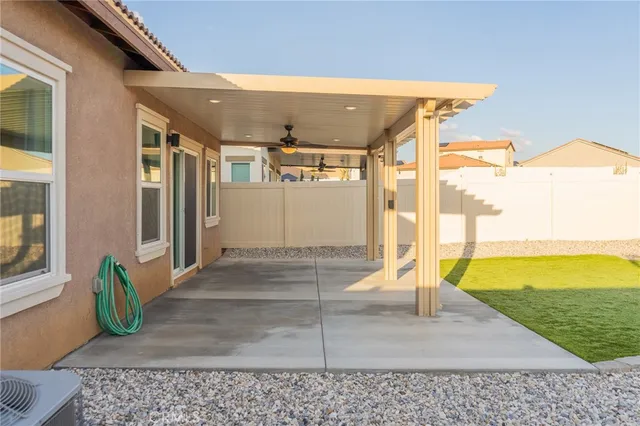 a swimming pool with outdoor seating and plants
