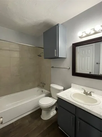 a bathroom with a sink a toilet and a bathtub