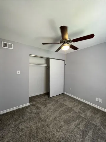 a view of room with a ceiling fan