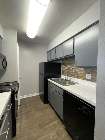 a kitchen with stainless steel appliances granite countertop a sink and a stove