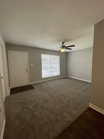 an empty room with windows and closet