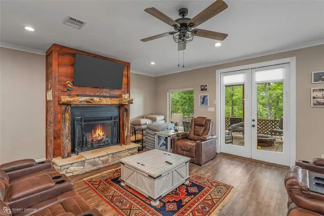 a living room with furniture a flat screen tv and a fireplace