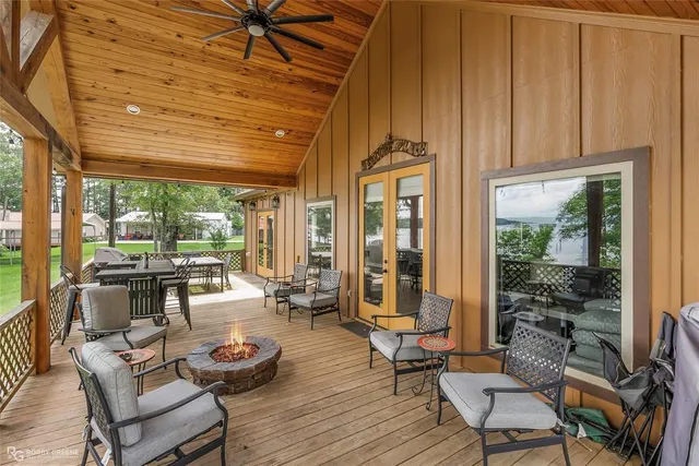 a living room with furniture and large windows