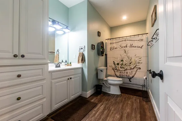 a bathroom with a toilet a sink and mirror