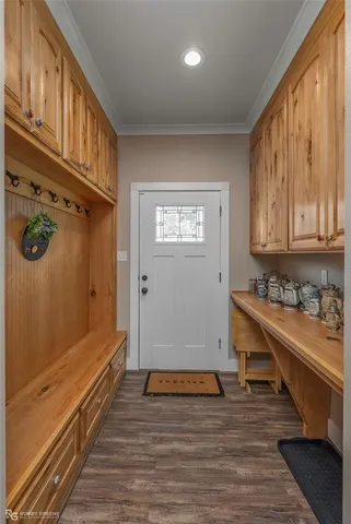 a view of a hallway with wooden floor and staircase