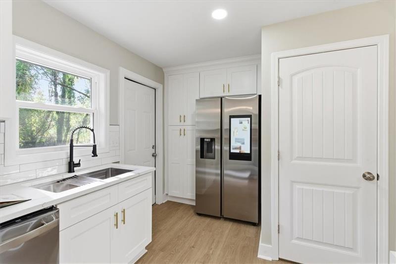 4015 Moffat Court Decatur, GA 30035 - Photo 10 of 34 a kitchen with a refrigerator sink and cabinets