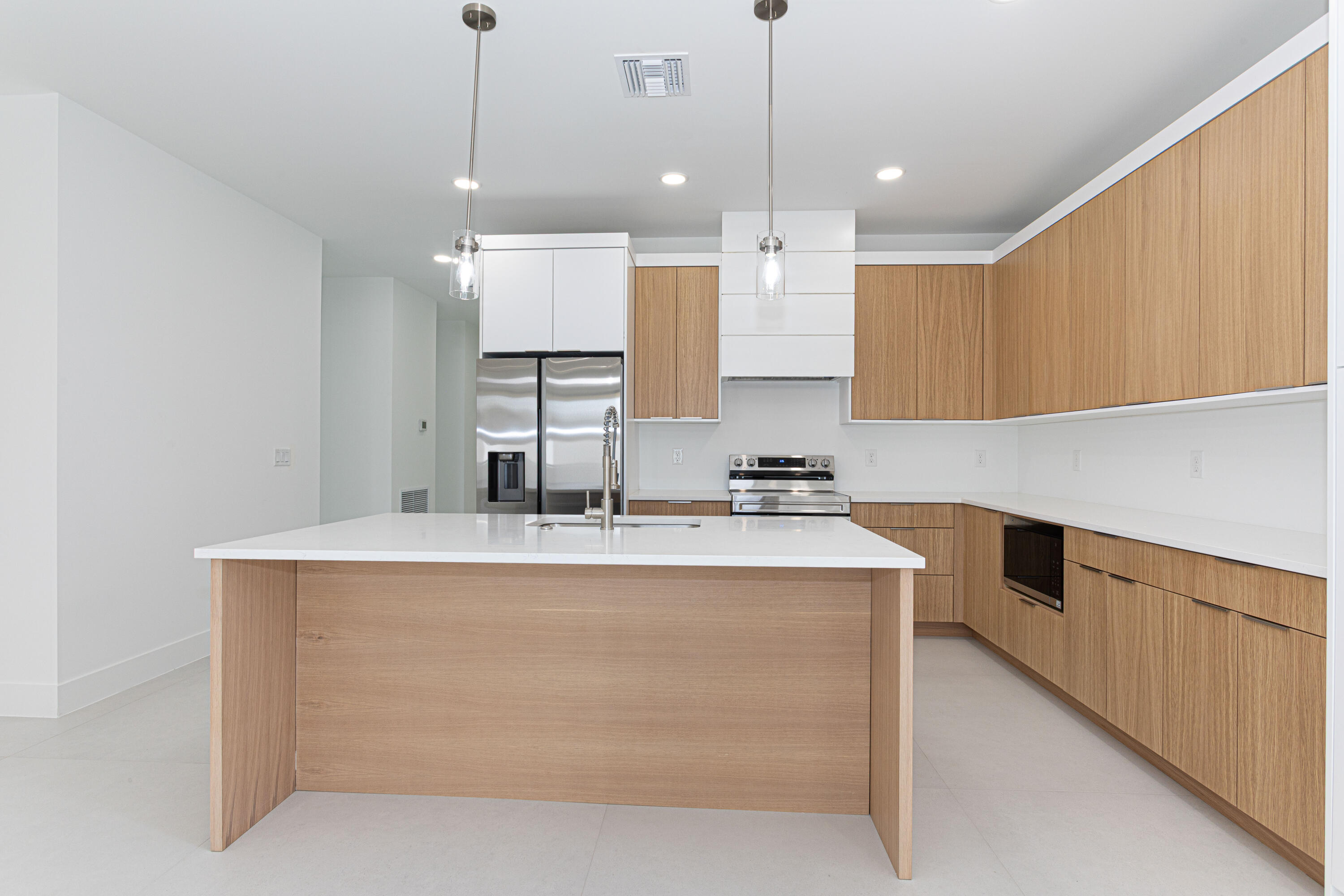 308 4th Street Jupiter, FL 33458 - Photo 12 of 51 a large kitchen with kitchen island a stove a sink a center island and a cabinets