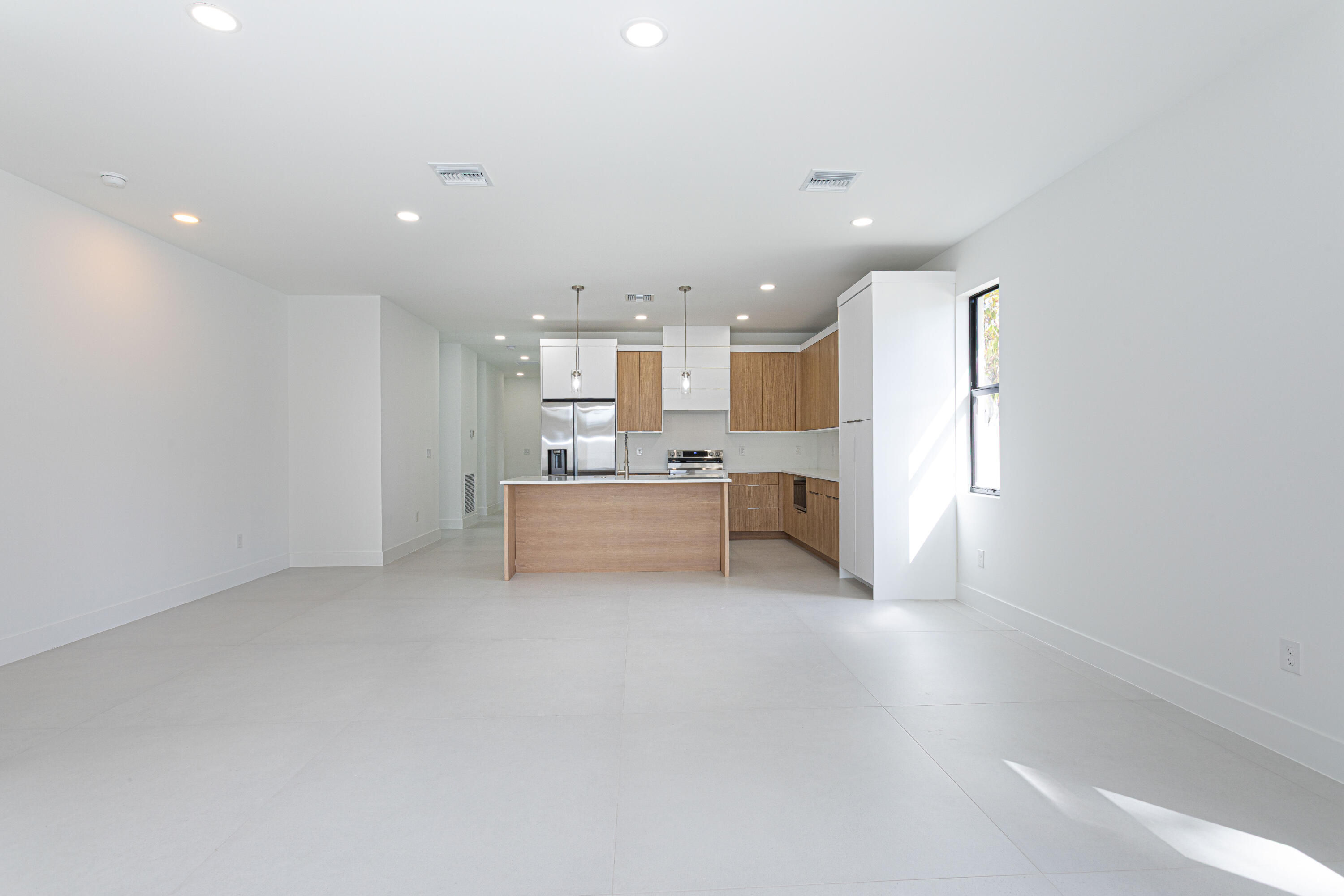 308 4th Street Jupiter, FL 33458 - Photo 13 of 51 a view of a kitchen with a sink and a refrigerator