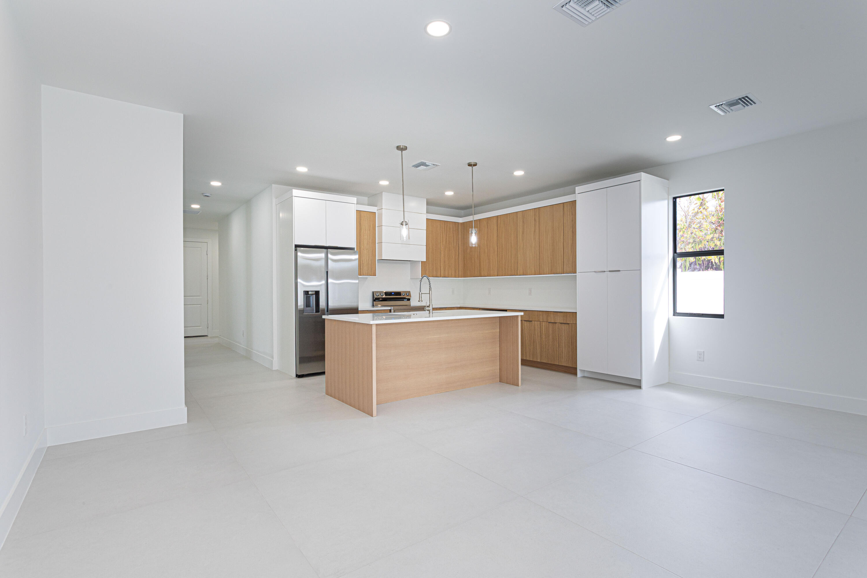 308 4th Street Jupiter, FL 33458 - Photo 15 of 51 a large kitchen with a large counter top stainless steel appliances and cabinets