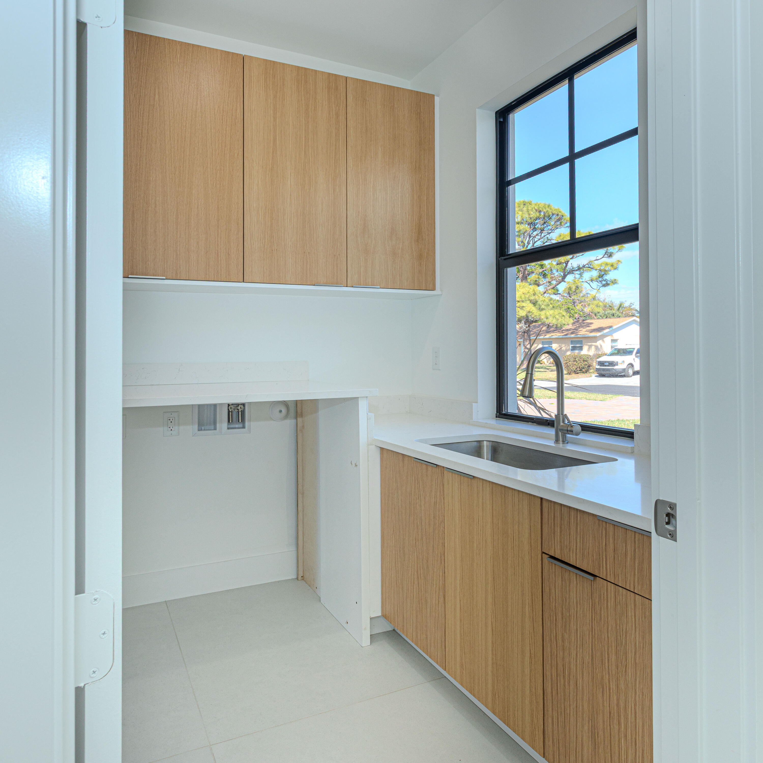 308 4th Street Jupiter, FL 33458 - Photo 37 of 51 a kitchen with a sink window and cabinets