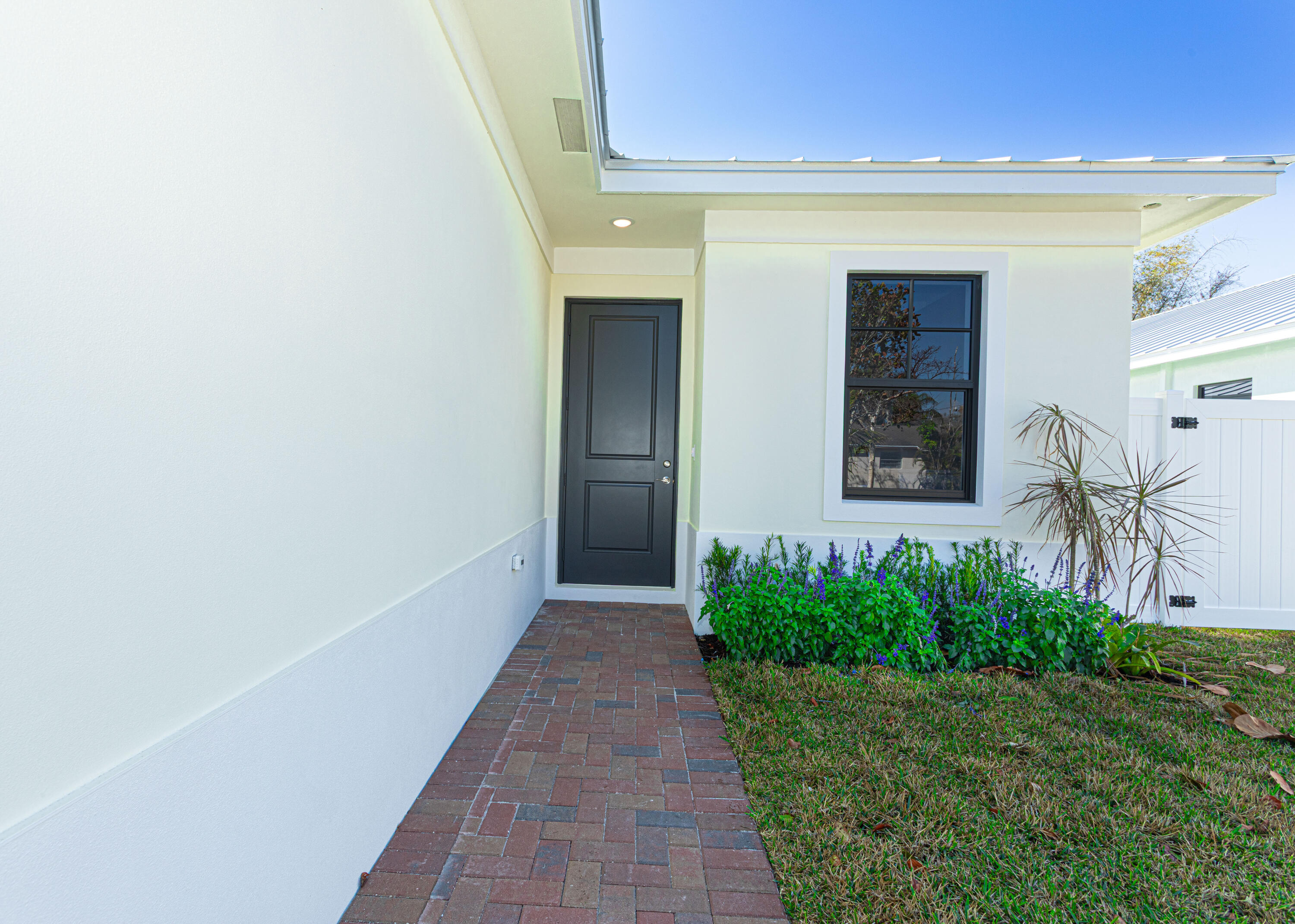 308 4th Street Jupiter, FL 33458 - Photo 4 of 51 a front view of a house with a yard